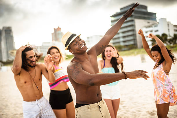 istock friends dancing on the beach for a party 510409480