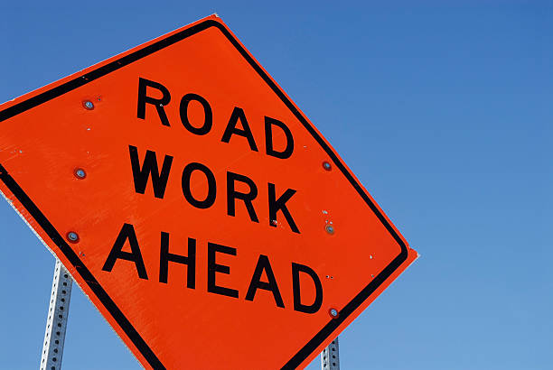 Road work Construction road sign against a blue sky road construction stock pictures, royalty-free photos & images