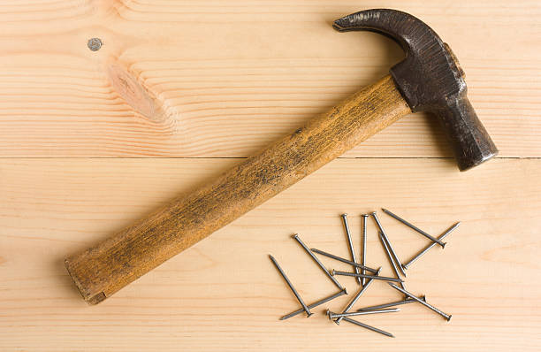 istock Old hammer and iron nails on wooden floor 510412117