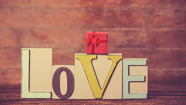istock Little gift and word Love on wooden table. 510413593