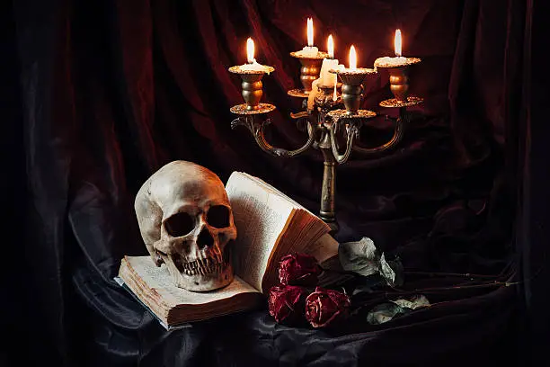 Photo of Still life with skull, book and candlestick