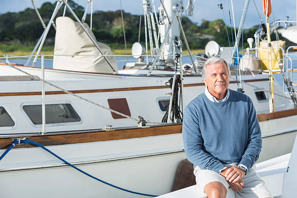 istock Senior man at boat dock sitting on yacht 510414172