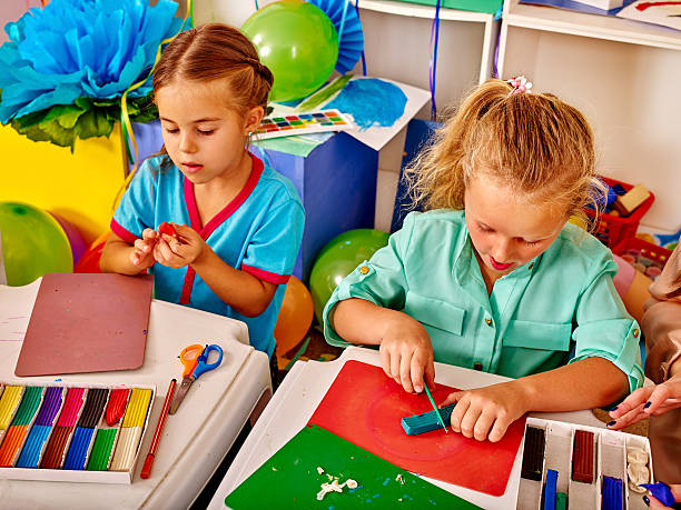istock Group girls mold from plasticine  in kindergarten 510414272
