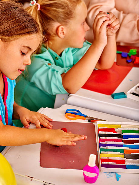 istock Group kids mold from plasticine  in kindergarten 510414314