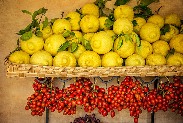 Lemons grown on Amalfi Coast Italy Lemons with tomatoes for sale at a market in Amalfi, Italy amalfi photos stock pictures, royalty-free photos & images