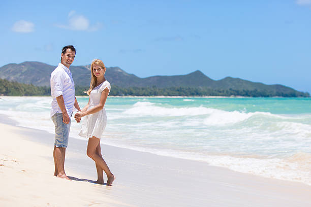 istock Happy couple walking on beach. 510414517