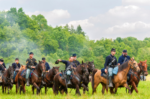 Bath, OH, USA - August 9, 2014: Union cavalry troops ride by in parade after victory in the 3rd Battle of Winchester (1864) in a Civil War reenactment at Hale Farm and Village in Ohio.