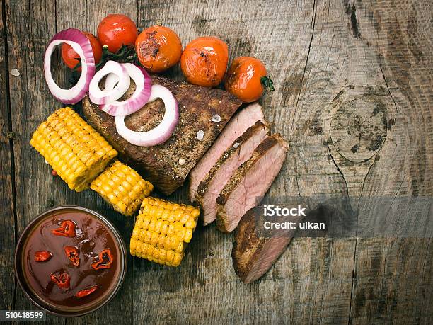 Delicious Beef Steaks On Wooden Table Stock Photo - Download Image Now - Barbecue - Meal, Beef, Cooked
