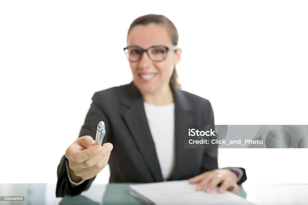 young business woman offering a pen young business woman offering a pen to sign a document sitting on a desk - focus on the pen Adult Stock Photo