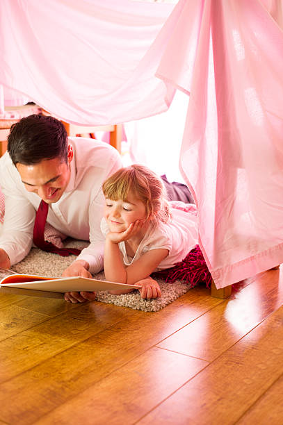 istock father and daughter storytime 510437071