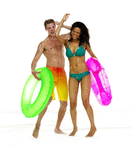 zwei personen mit badebekleidung & tanzen im wasser - happy men rain water dance stock-fotos und bilder