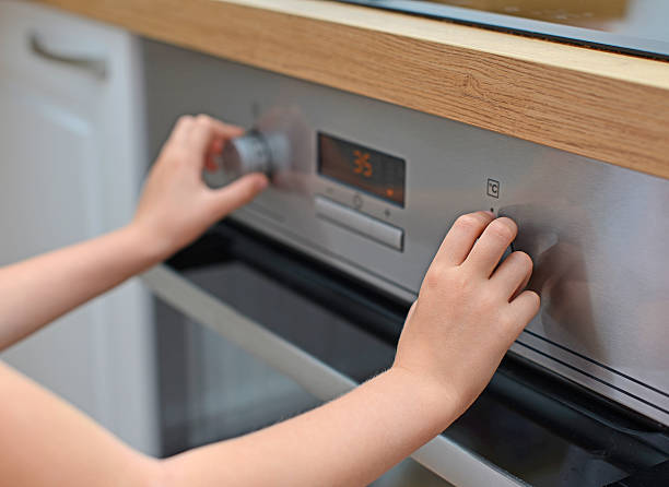 istock Dangerous situation in the kitchen. Child playing with electric oven. 510437787