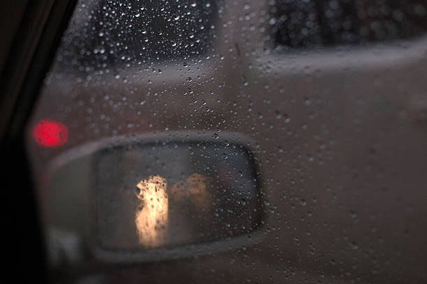 istock Droplets and car lights reflections through foggy car 510438301