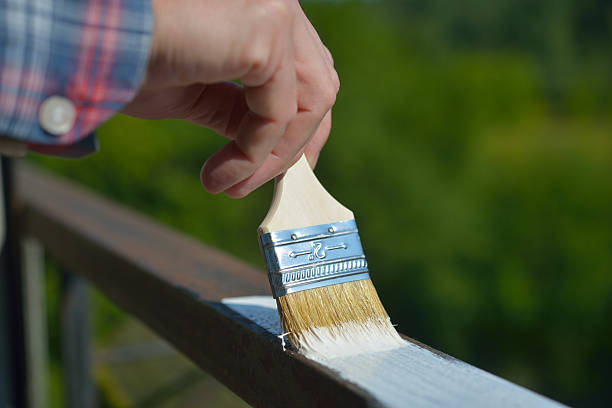 Man painting a guardrail stock photo