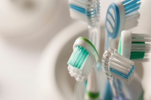 A families toothbrushes in a toothbrush holder with copy space