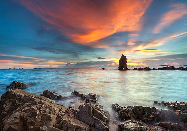 istock sunset waves lash line impact rock on the beach 510439391