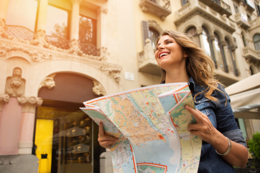 Mid age woman traveling, holding map. Europe, Barcelona.