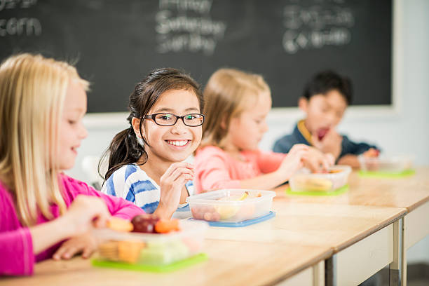 Elementary Students Elementary students eating healthy lunches food elementary student healthy eating schoolboy stock pictures, royalty-free photos & images