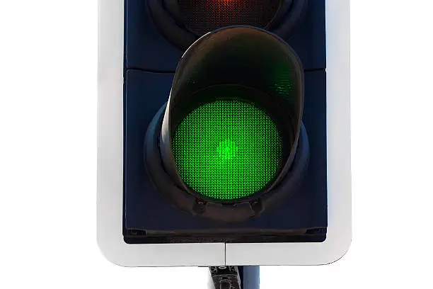 Green traffic light close up isolated on white