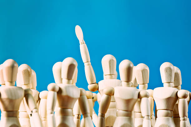 istock Standing out from the crowd, single figure raising arm 510442495
