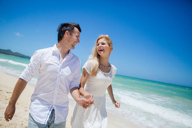 istock Couple running on a sandy beach 510442767