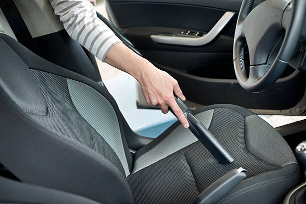 istock Man hoovering a car cabin 510443171