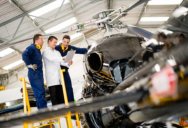 Mechanics fixing a helicopter