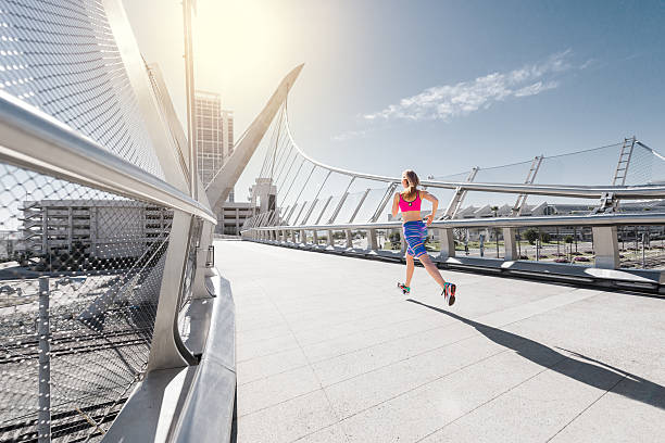 istock Women Running Across A Bridge In Downtown 510461376