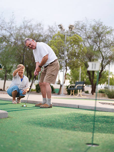 istock senior couple playing mini golf 510462963