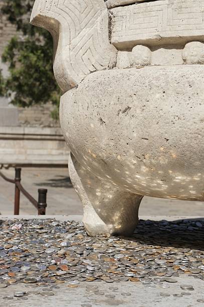 istock Coins near Stone Pot 510463145