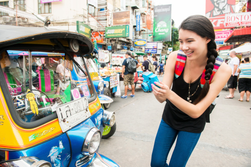 Solo female traveler has fun on Khao San Road in Bangkok, Thailand