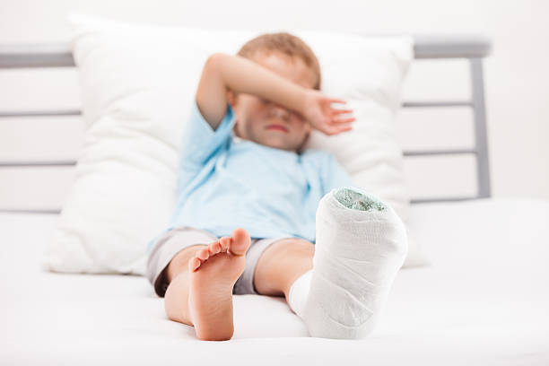 Child leg heel fracture or broken foot bone plaster bandage stock photo