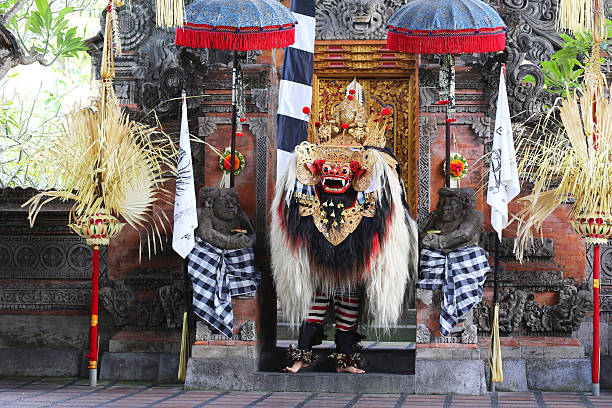 Denpasar, Indonesia - August 22, 2014: Barong, a mythical lion-like creature at a traditional ceremony in Bali. The depiction of the battle between good and evil intertwines local history and mythology to create a parable for all ages.