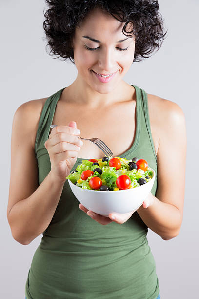 istock Young woman & vegetable salad isolated 510467881