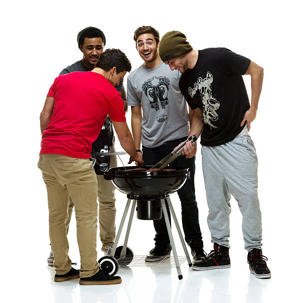Social group of young men having a BBQ