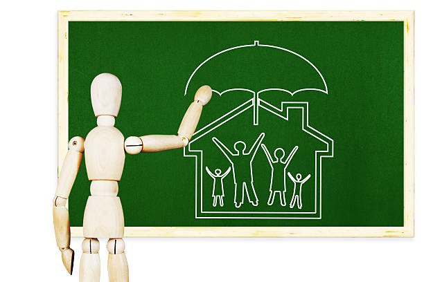 Man draws symbol of traditional family and moral values Man draws symbol of traditional family and moral values on the green chalkboard. Abstract image with a wooden puppet man writing on white board stock pictures, royalty-free photos & images