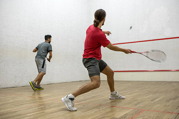 istock Two men playing racketball on a court. 510474926