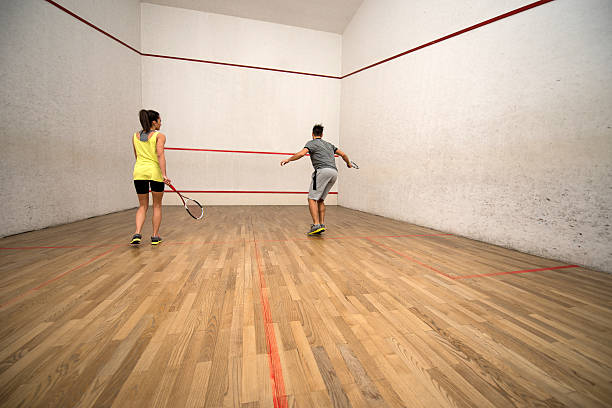 istock Back view of athletes playing racketball on a court. 510475646