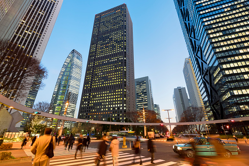 Commuters rushing home after office hours  in Shinjuku, Tokyo - Japan.