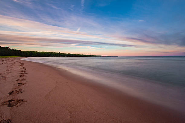 Sunset over Lake Superior A long exposure captures the smoothness of the waves at the beach on Madeline Island in the Apostle Islands in Lake Superior bayfield county stock pictures, royalty-free photos & images