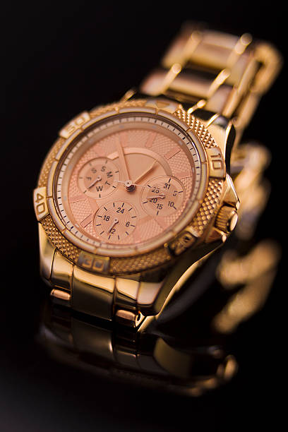 istock Gold watch on a plastic background 510479190