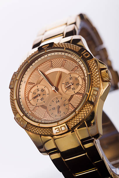 istock Gold watch on a plastic background 510479516