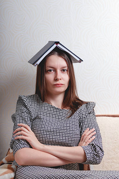 istock Woman holding book over her head 510481856