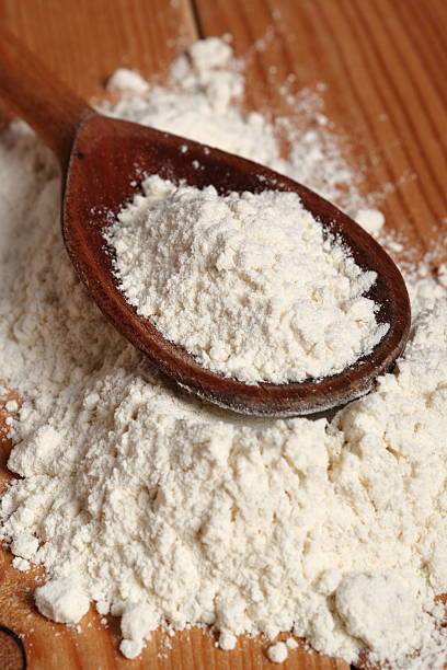istock Wheat flour on wooden spoon 510482322