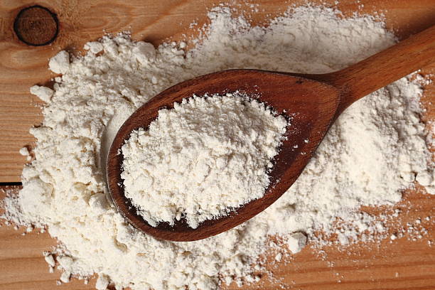 istock Wheat flour on wooden spoon 510482412
