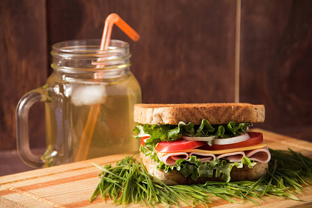 istock Sandwich and ice tea with grass, bread and ham 510483066