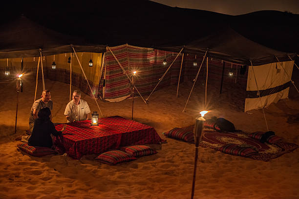 Middle Eastern and Multi-Ethnic Friends Enjoying Conversation at Desert Camp