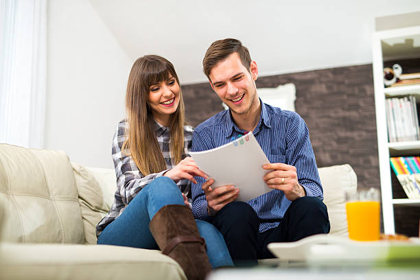 istock Couple discuss about paperwork together at home 510485302