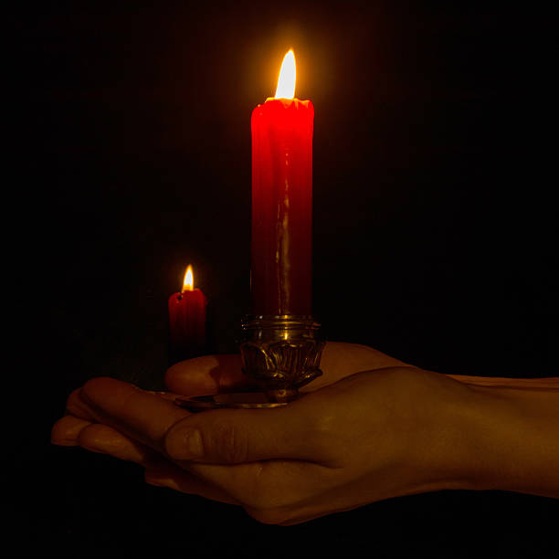 istock Red candle in woman hands 510489371