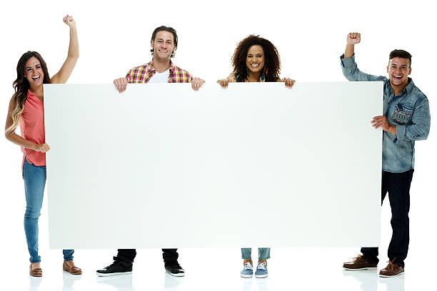 istock Smiling four friends holding placard & cheering 510490267